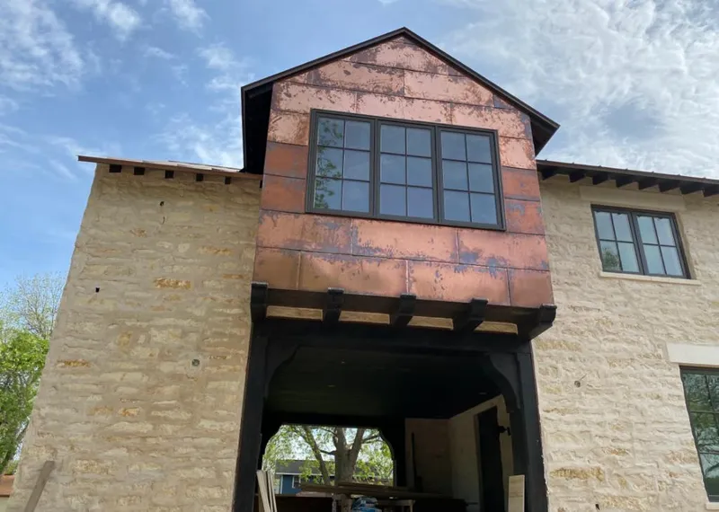 Copper metal panel facade on a stone building for Skylight Installation in Shelby